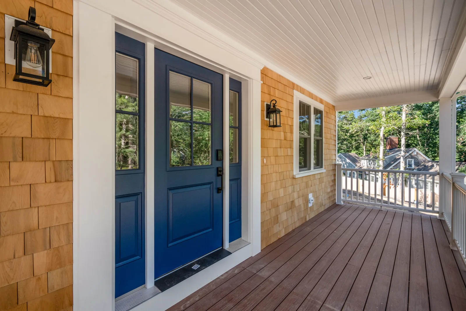 Farmer's porch with blue double front doors and cedar shingles